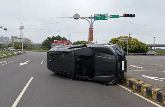 台灣新聞通訊社-新手妹練車「打方向盤緊張」!休旅車撞分隔島翻覆 嚇壞副駕老爸