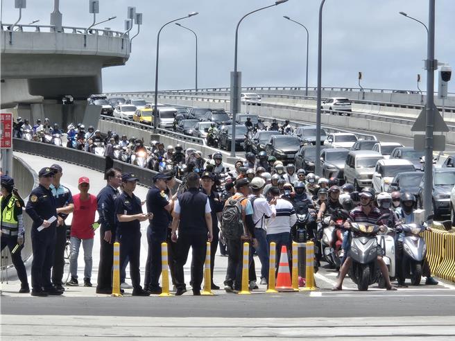 台灣新聞通訊社-淡江大橋正式通車湧萬人朝聖 騎士偷跑硬闖遭警攔截開罰